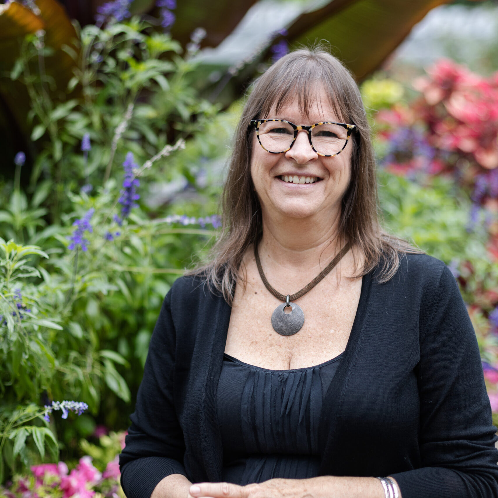 Lucy White outside in a flower garden Photo of Lucy White